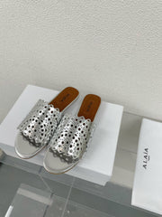 ALAIA VIENNE FLAT MULES IN SILVER LAMBSKIN