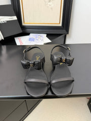 FLAT SANDALS IN BLACK CALFSKIN WITH BOW