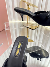 MIUMIU 26S MULE SANDALS 55MM IN BLACK SUEDE WITH BOW