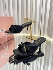 MIUMIU 26S MULE SANDALS 55MM IN BLACK SUEDE WITH BOW
