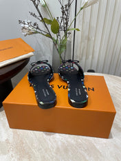 BOW FLAT MULES IN BLACK MONOGRAM LAMBSKIN