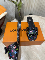 BOW FLAT MULES IN BLACK MONOGRAM LAMBSKIN