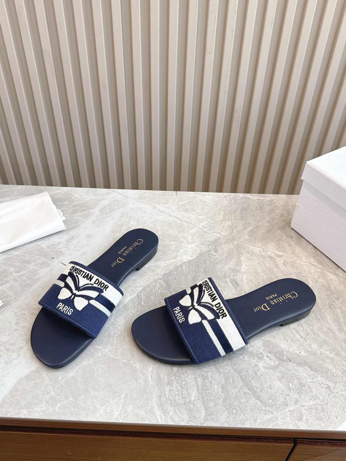 DIOR FLAT SLIDES 25S IN MIDNIGHT BLUE CALFSKIN AND FABRIC EMBROIDERED BUTTERFLY MOTIF