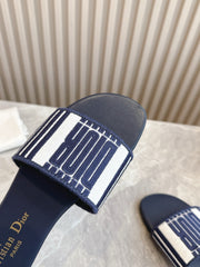 DIOR FLAT SLIDES 25S IN MIDNIGHT BLUE CALFSKIN AND FABRIC BRAND NAME EMBROIDERY