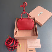 MICRO BAG KEYCHAIN 11 IN TALL POPPY RED CALFSKIN EMBOSSED LOGO
