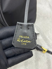 BUCKET BAG 19 IN BLACK RE-NYLON AND CALFSKIN HANDLE