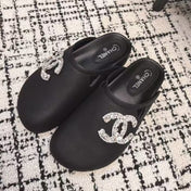 FLAT MULES IN BLACK CALFSKIN