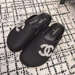 FLAT MULES IN BLACK CALFSKIN