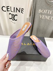 ALAIA FLAT MULES IN LIGHT PURPLE MESH FISHNET